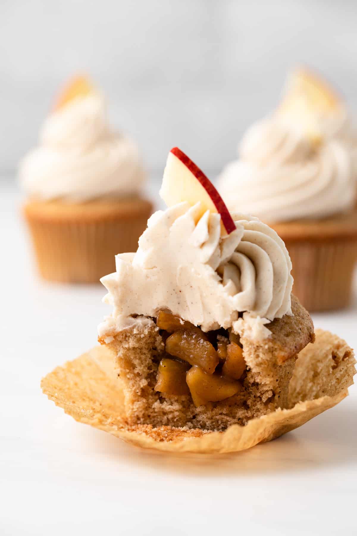 A spiced apple cupcake with a bite missing