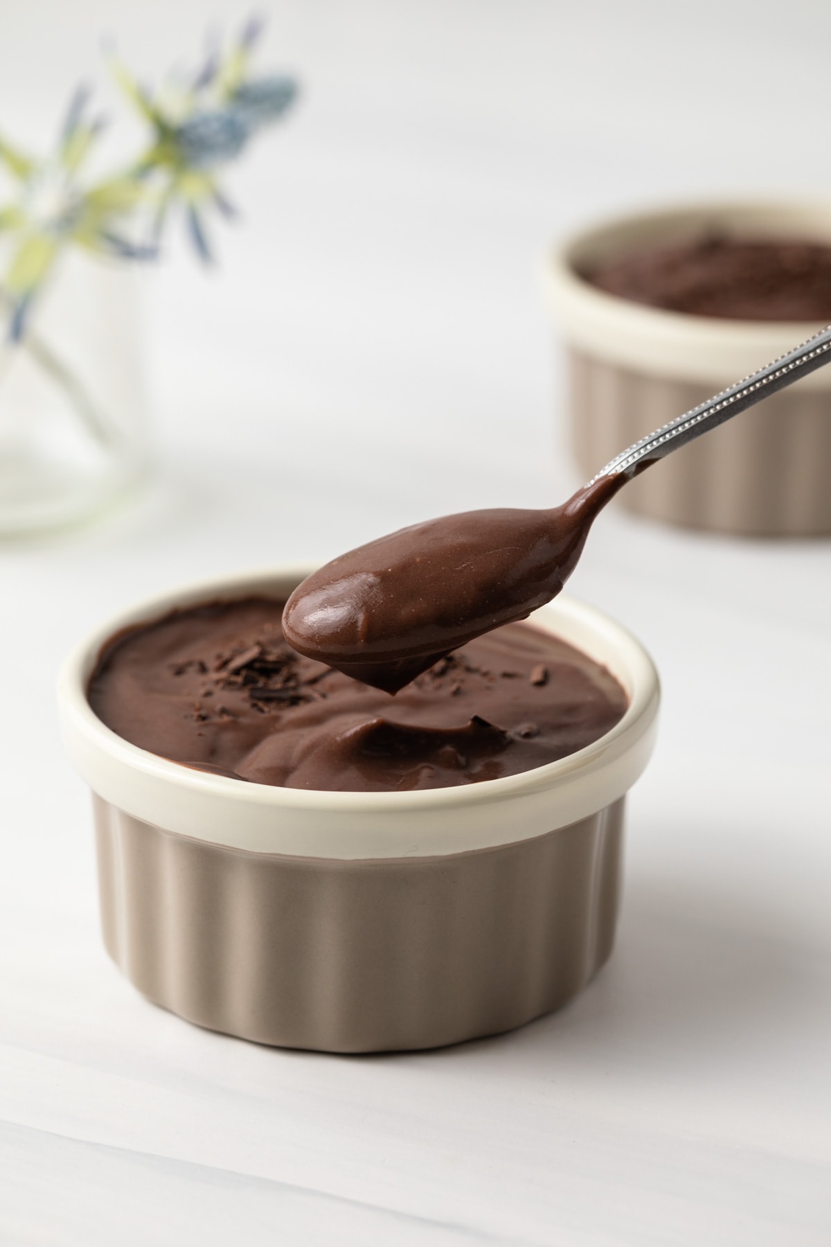 Chocolate pudding spooned out of a ramekin.
