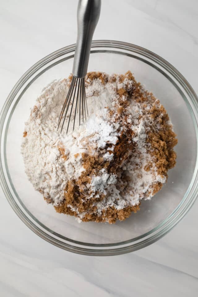Flour, brown sugar, and spices in glass mixing bowl.