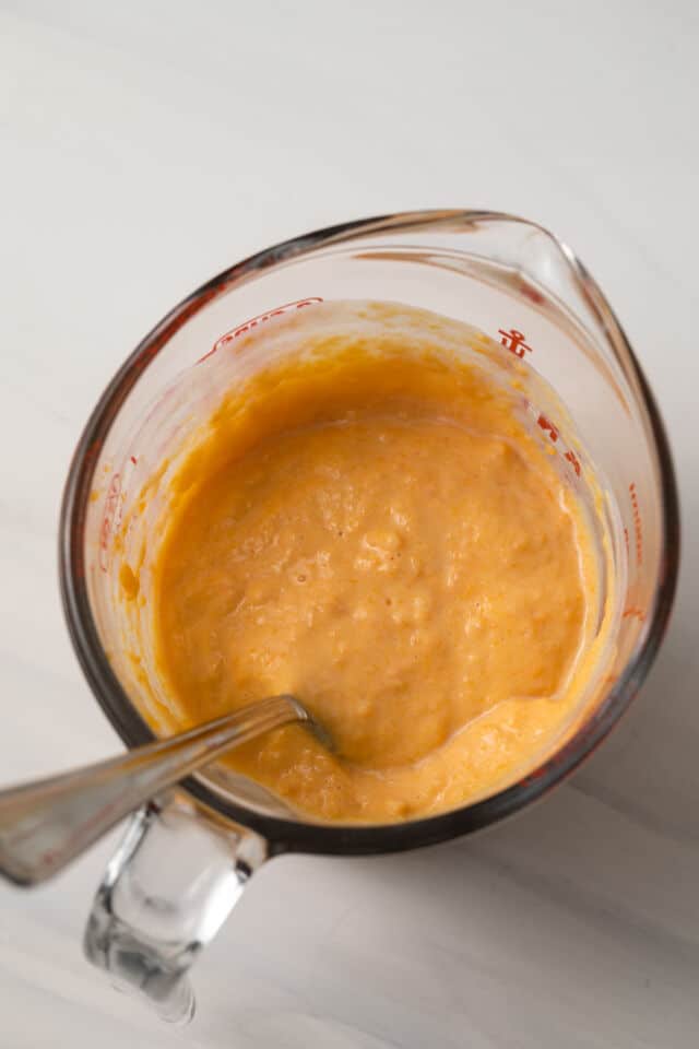 Sweet potato puree and buttermilk mixed in measuring cup.