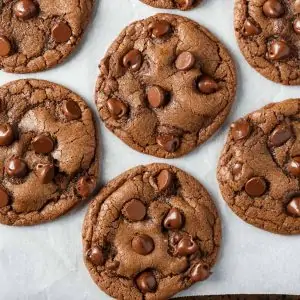 Overhead view of Double Chocolate Chip Nutella Cookies on white parchment paper.