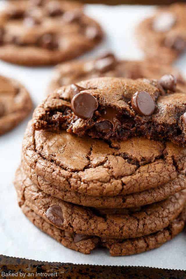 A stack of Double Chocolate Chip Nutella Cookies with a half a cookie on top.
