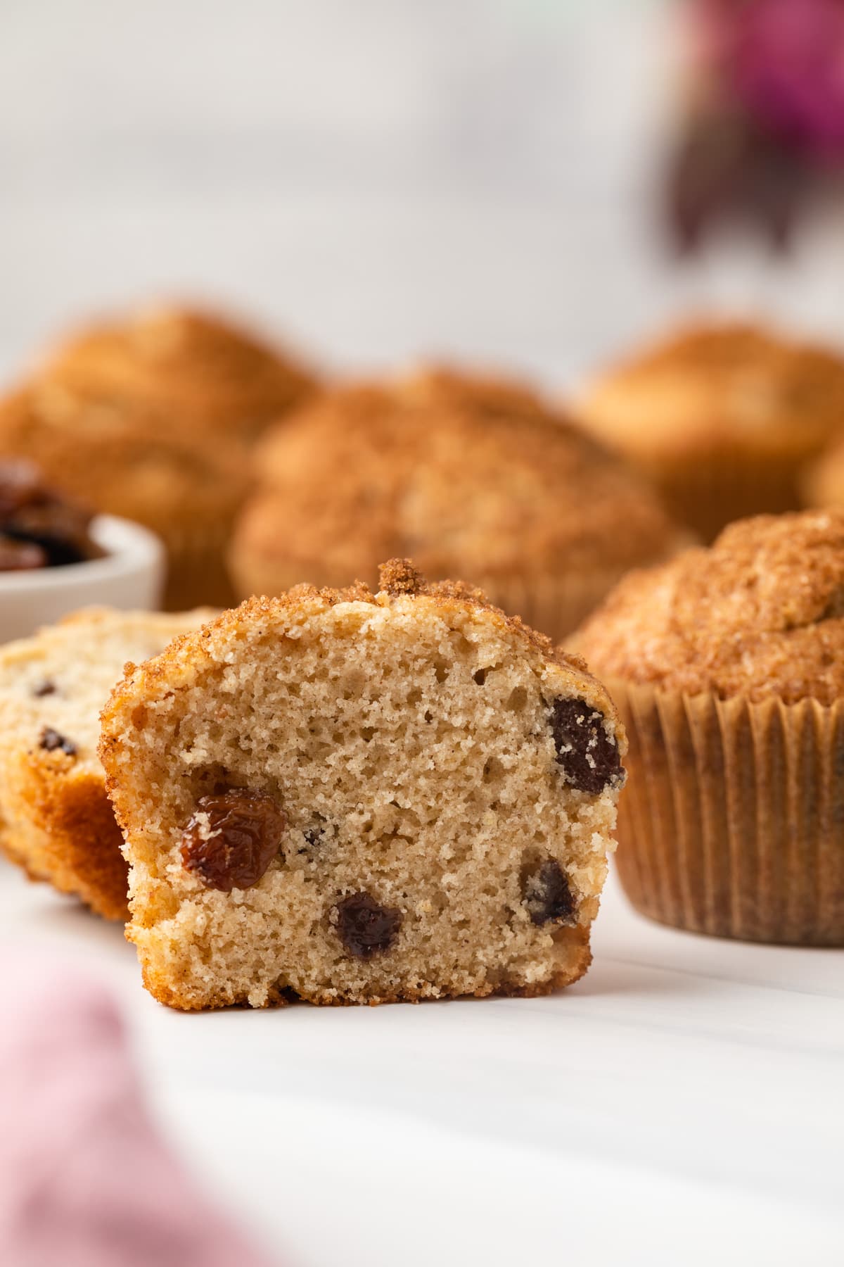 Cinnamon raisin muffin sliced in half.