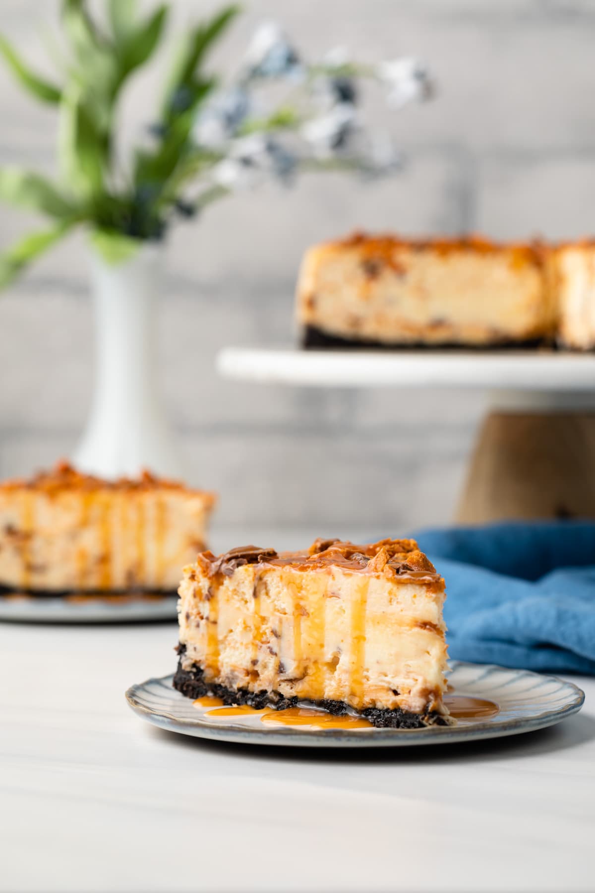 Slice of butterfinger cheesecake on plate.