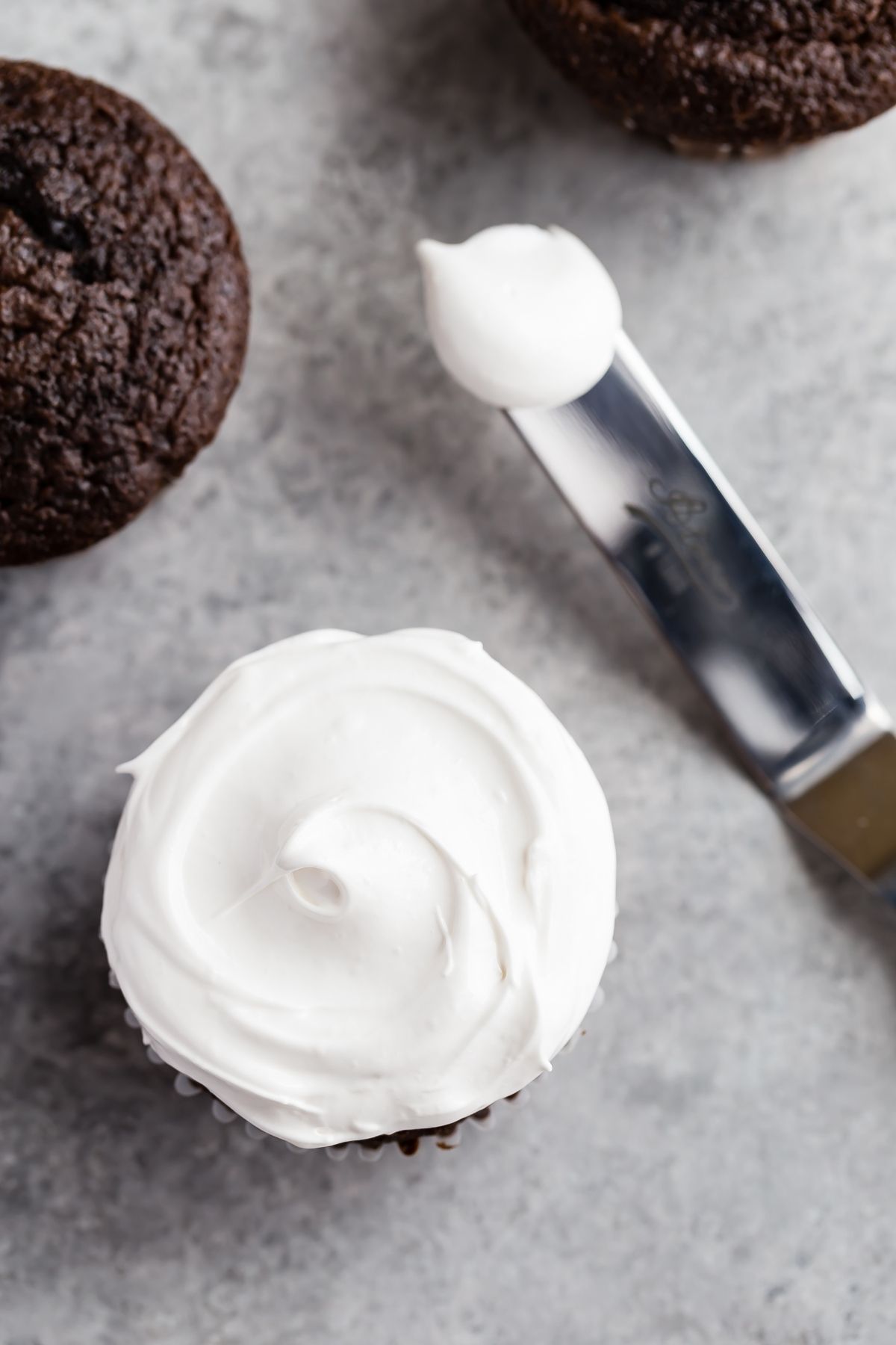 Overhead view of Marshmallow Frosting slathered over a chocolate cupcake.