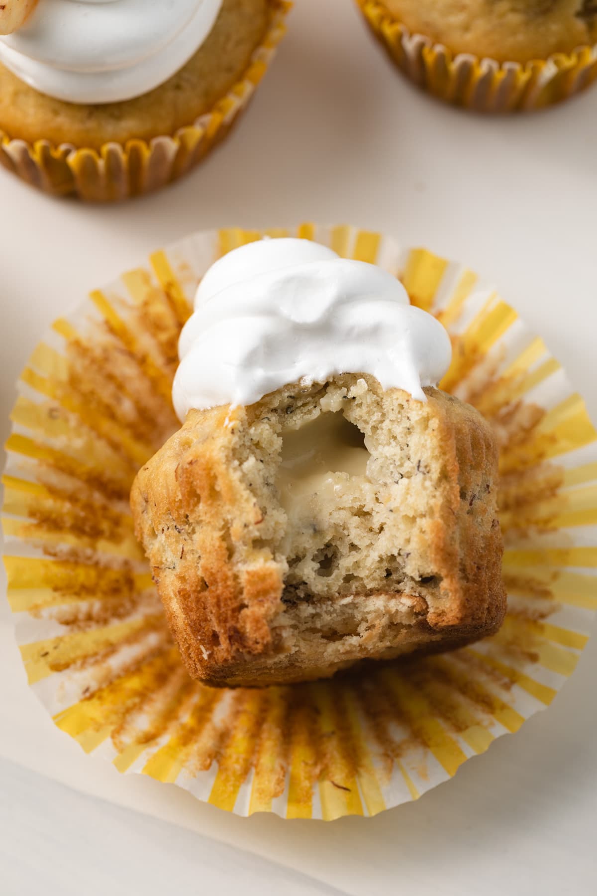 Banana pudding cupcake with a bite taken out.