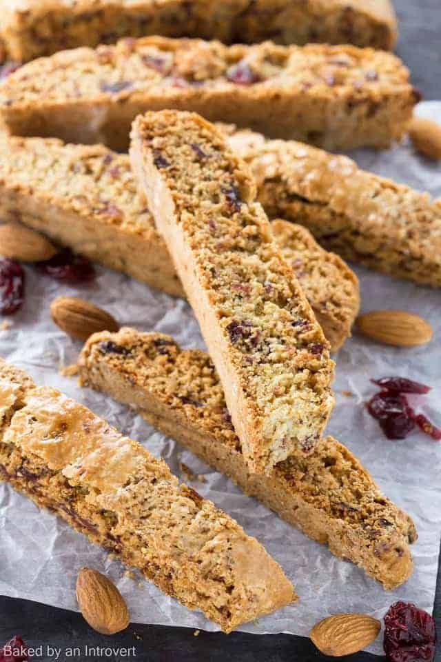 cherry almond biscotti stacked on a slate platter 