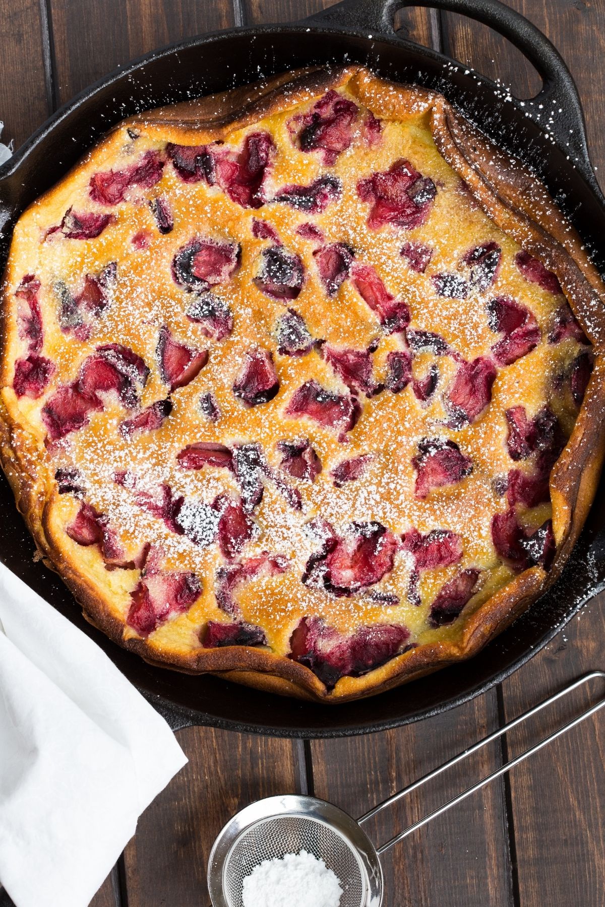overhead view of Roasted Plum Clafoutis in a cast iron pan