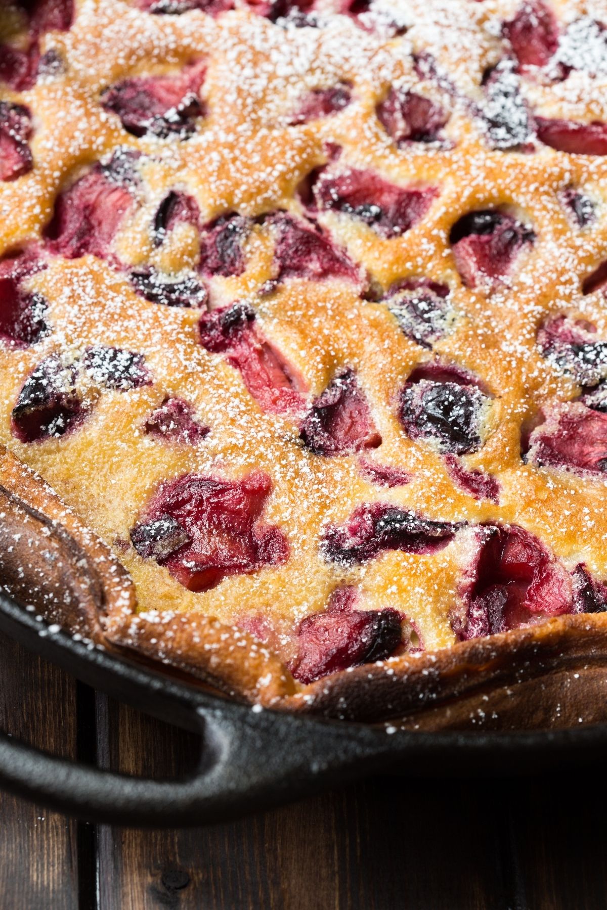 Roasted Plum Clafoutis dusted with powdered sugar