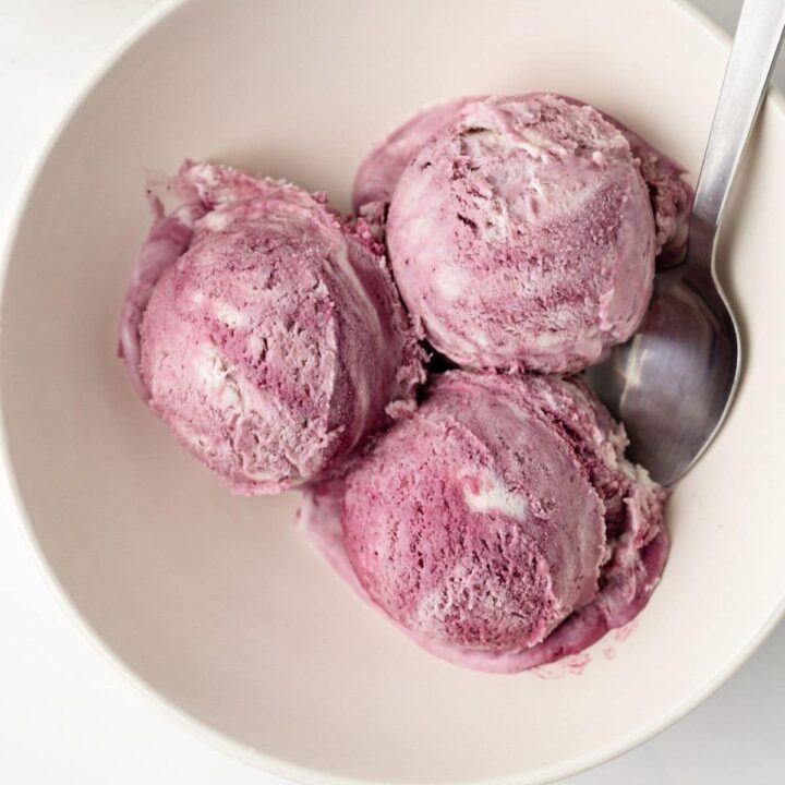 Overhead of blackberry ice cream in bowl.