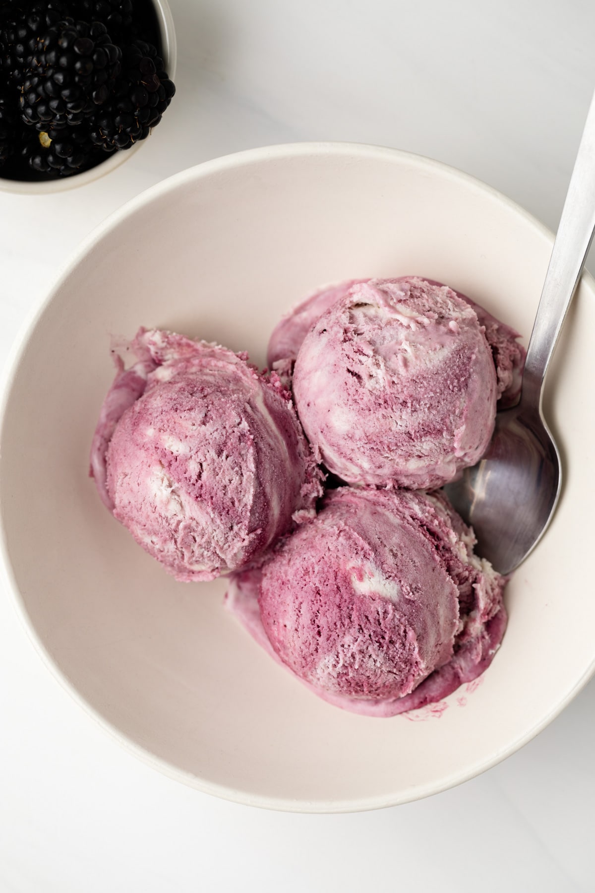 Overhead of blackberry ice cream in bowl.