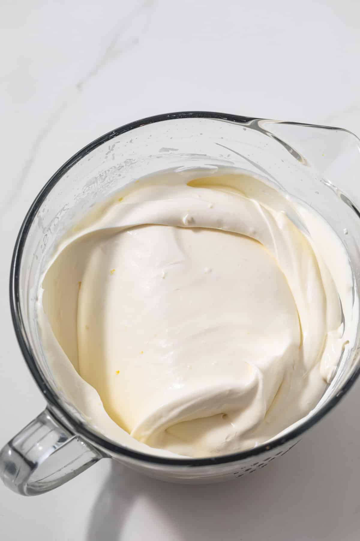 Lemon whipped cream in glass bowl.