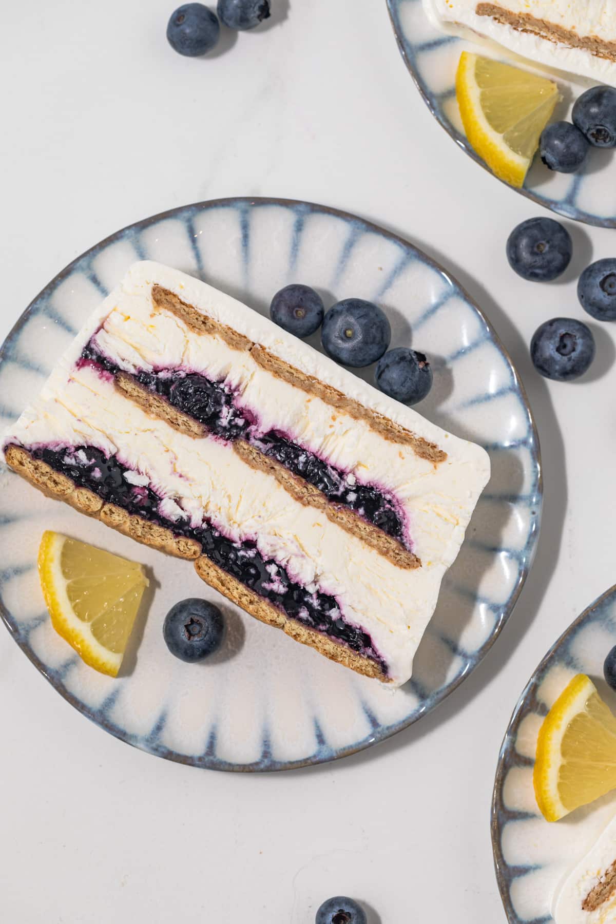 Overhead slice of blueberry lemon icebox cake on a plate.