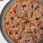 Overhead of sliced raspberry coffee cake on a serving platter.