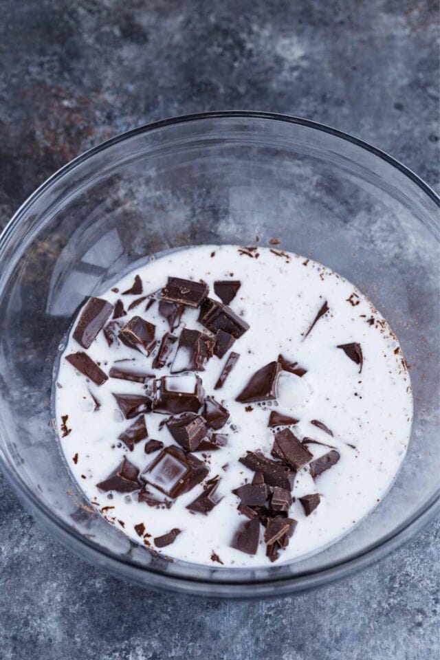 Dark chocolate and coconut milk in a glass bowl.