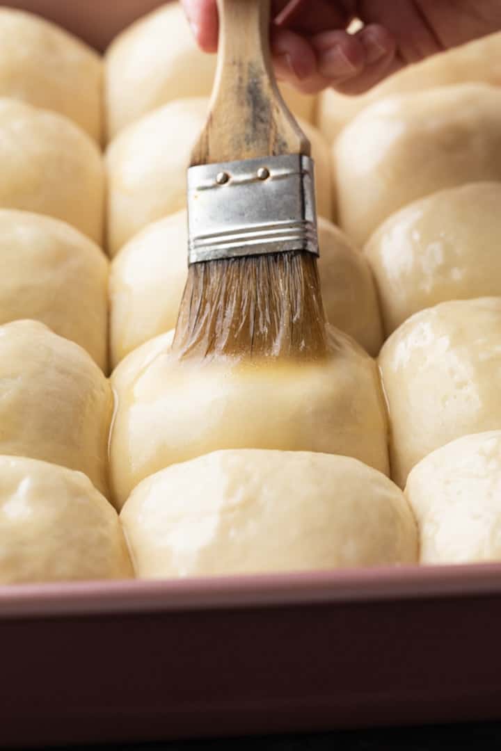 butter brushed over unbaked rolls