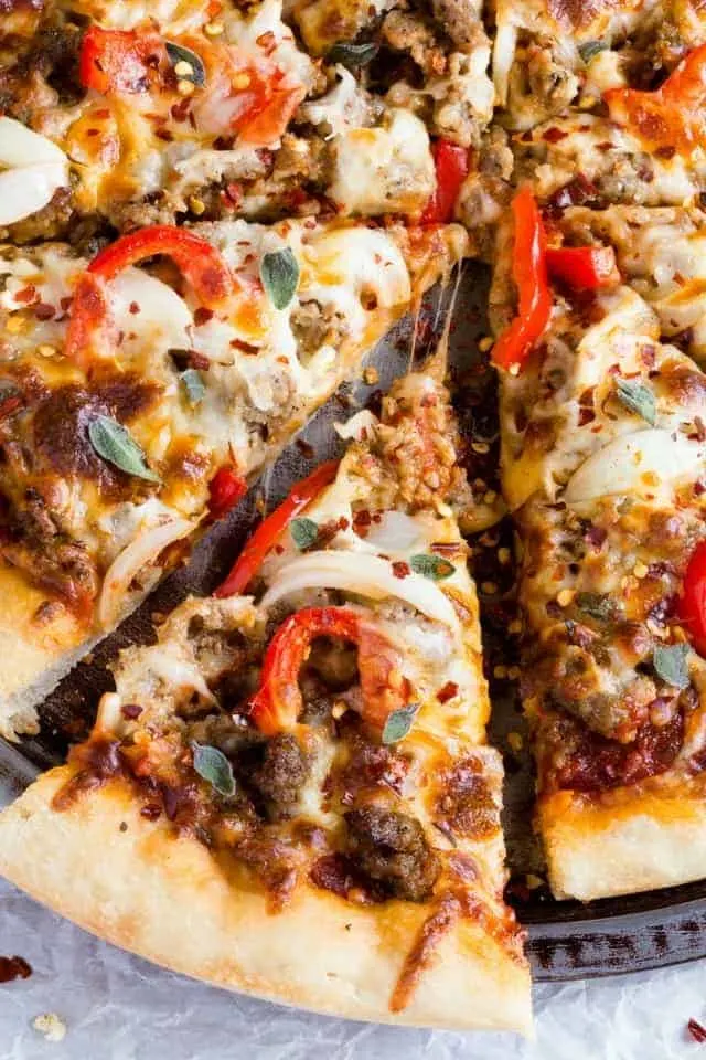 Up close view of a slice of spicy sausage pizza.