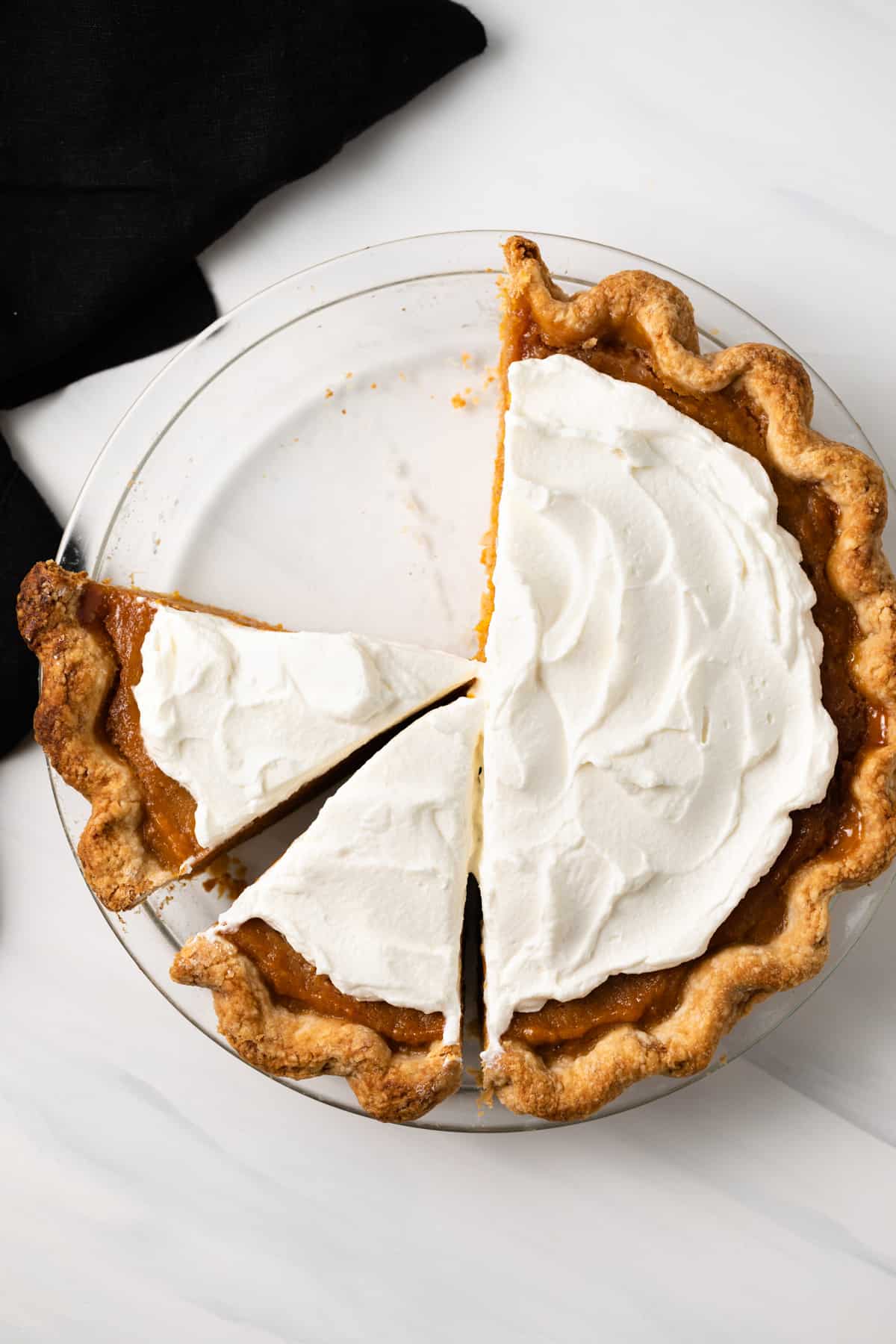 Homemade sweet potato pie topped with whipped cream