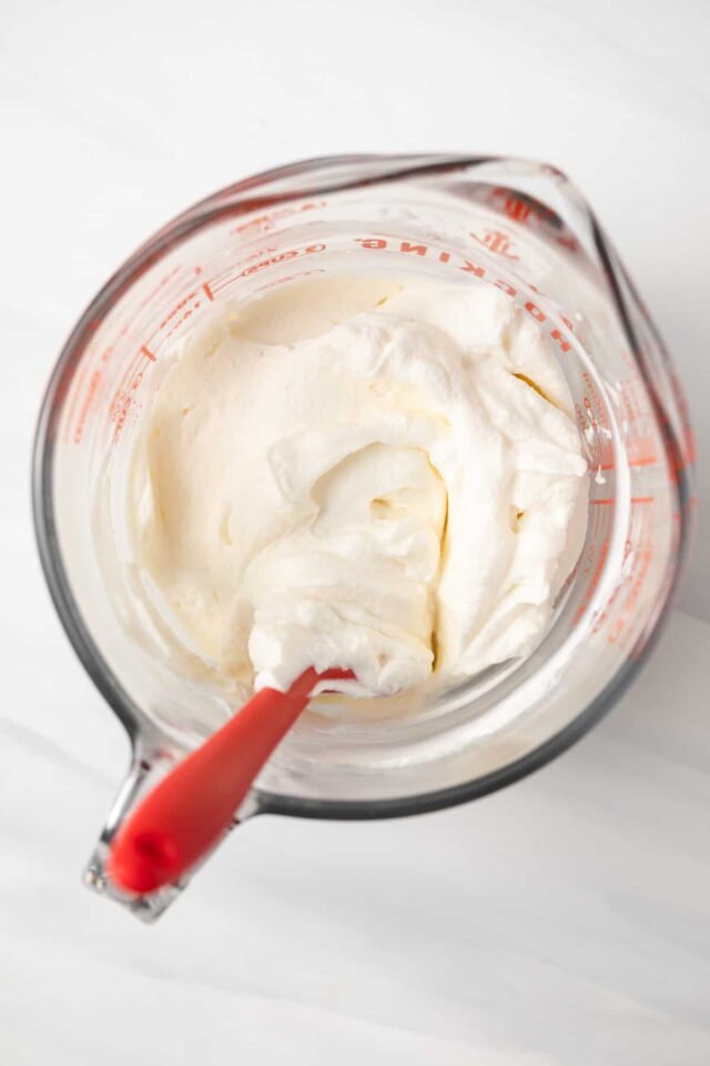 Homemade whipped cream in a mixing bowl