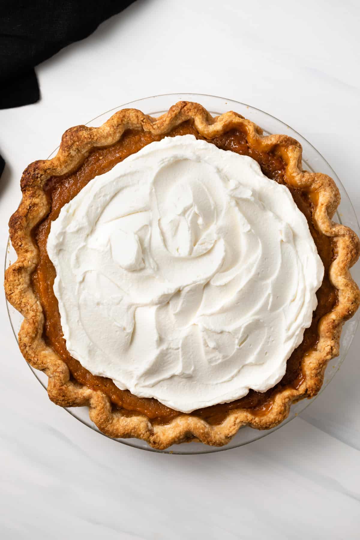 Overhead view of caramel sweet potato pie with whipped cream