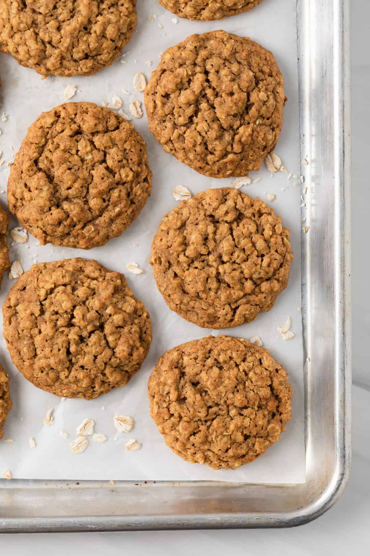 Baked pumpkin oatmeal cookies on baking sheet with parchment paper