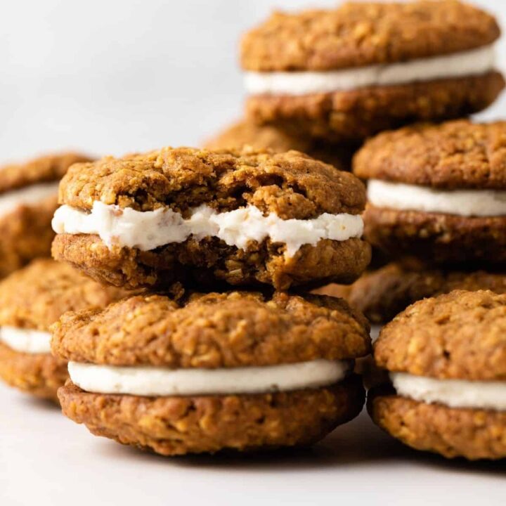 A stack of pumpkin oatmeal cream pies, one with a bite missing