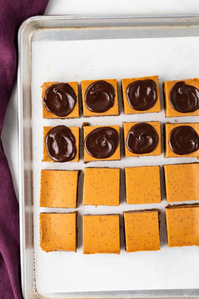 Pumpkin s'mores bars, half topped with chocolate ganache