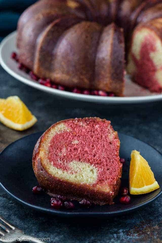 A slice of tequila sunrise cake on a dark blue plate.