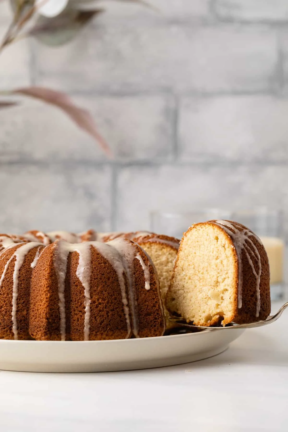 An eggnog bundt cake with one slice being served