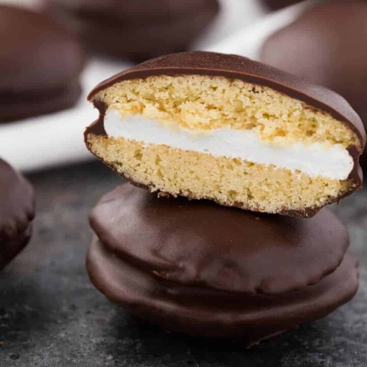 Half a moon pie stacked on top of a whole cookie.