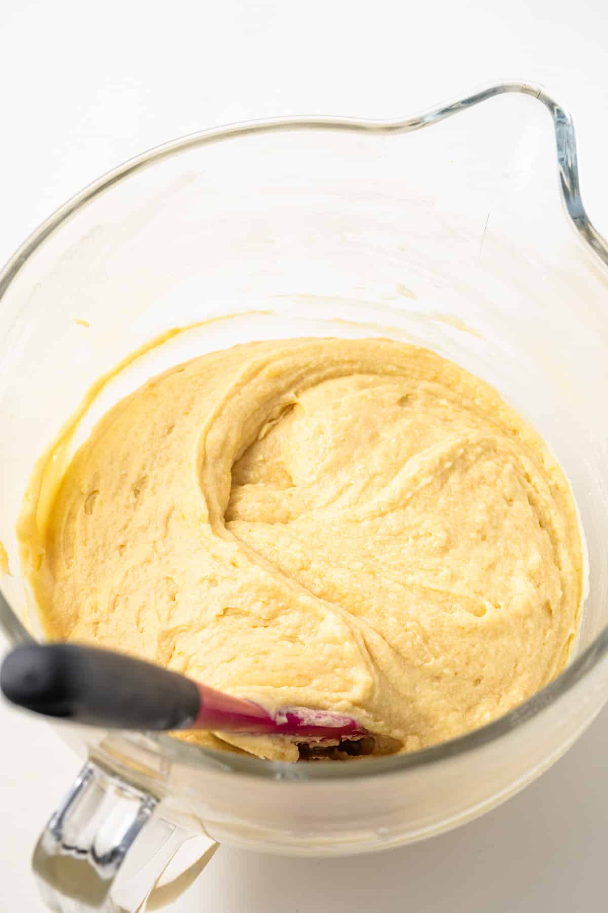 Cake batter in a glass mixing bowl.