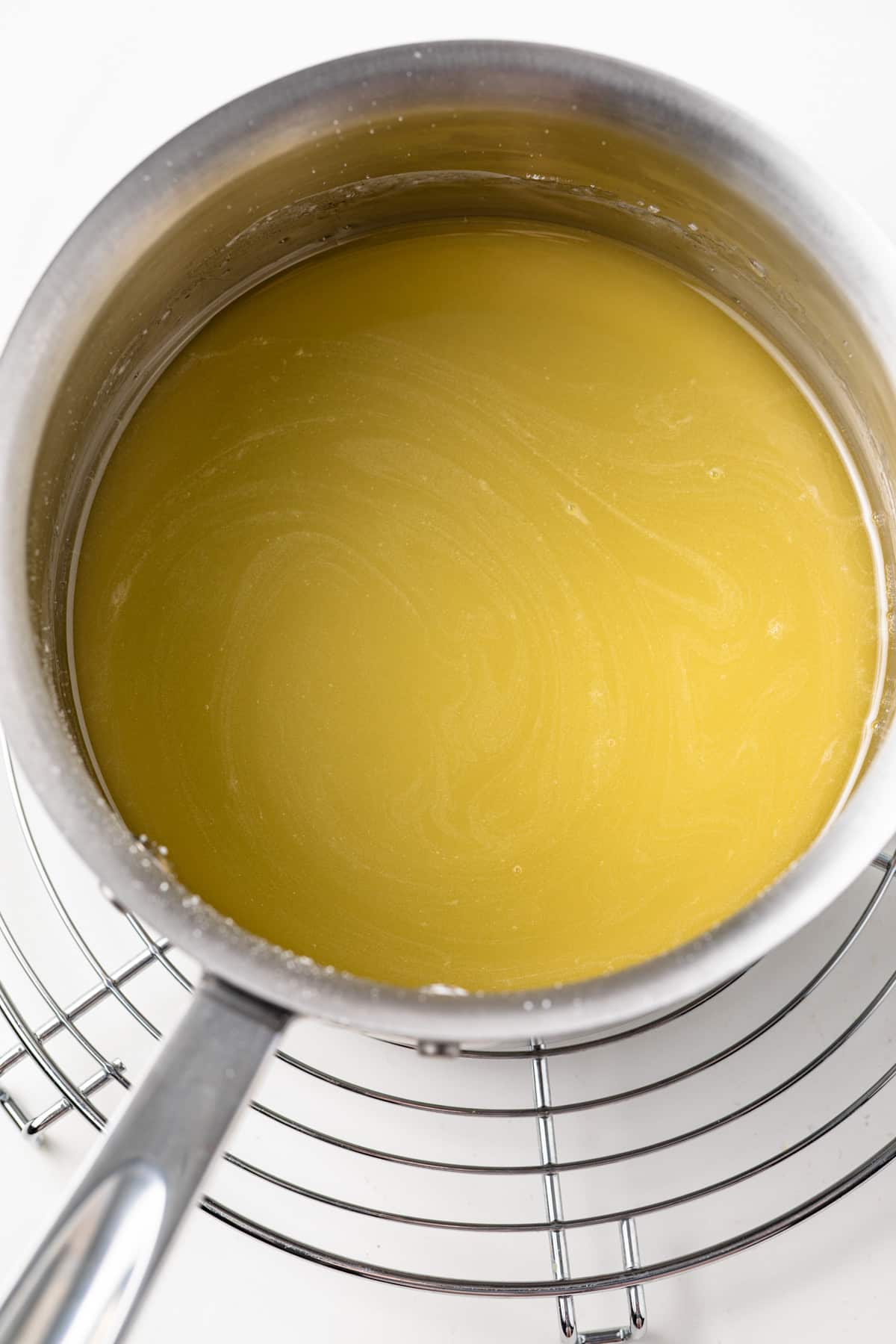 Orange syrup in a saucepan.