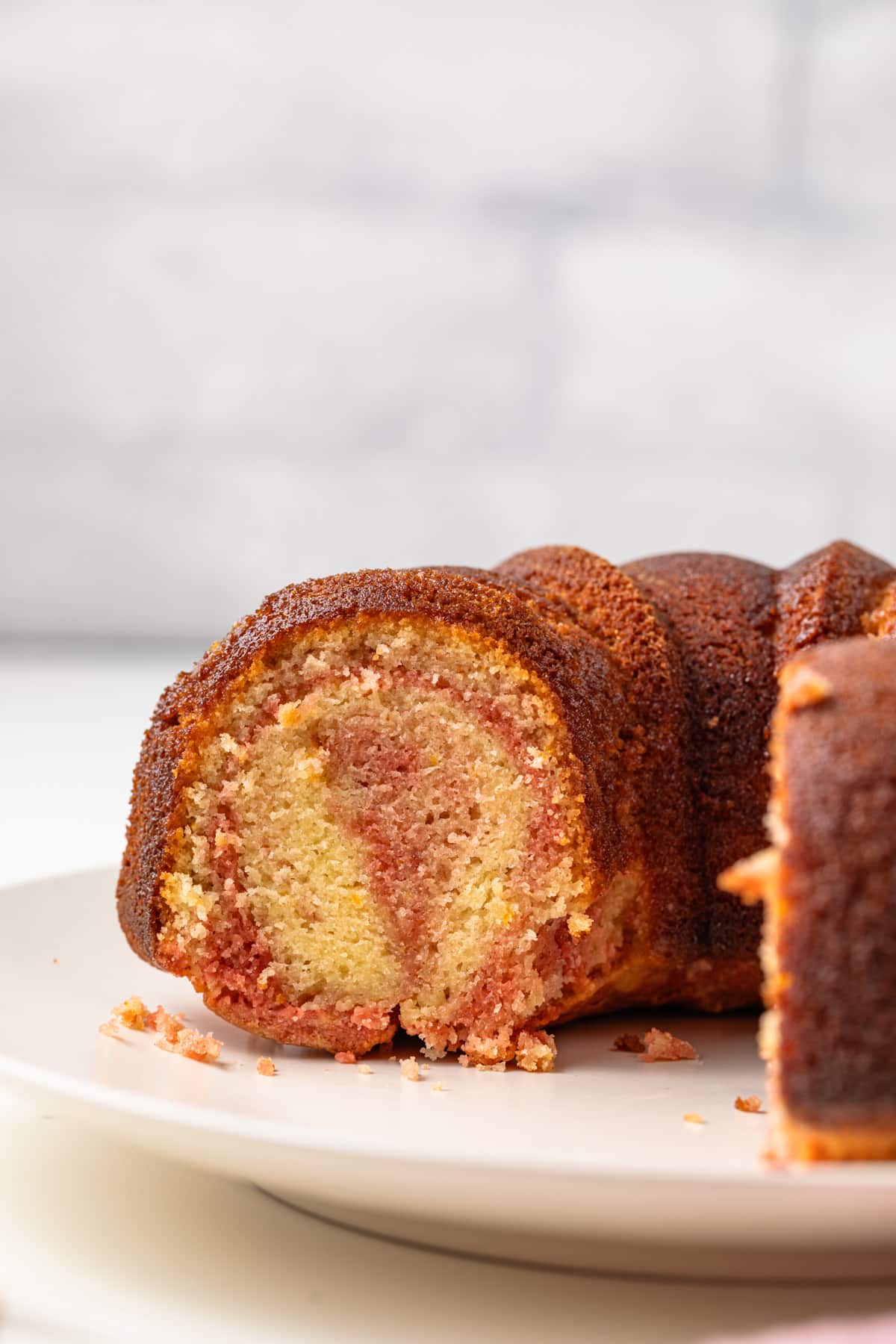 Tequila sunrise cake with a slice taken out.