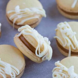 angled view of Salted Caramel Ginger Macarons on a fabric background