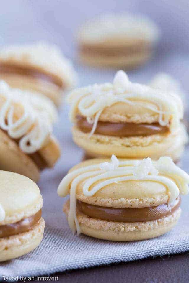 Salted Caramel Ginger Macarons stacked on a fabric background