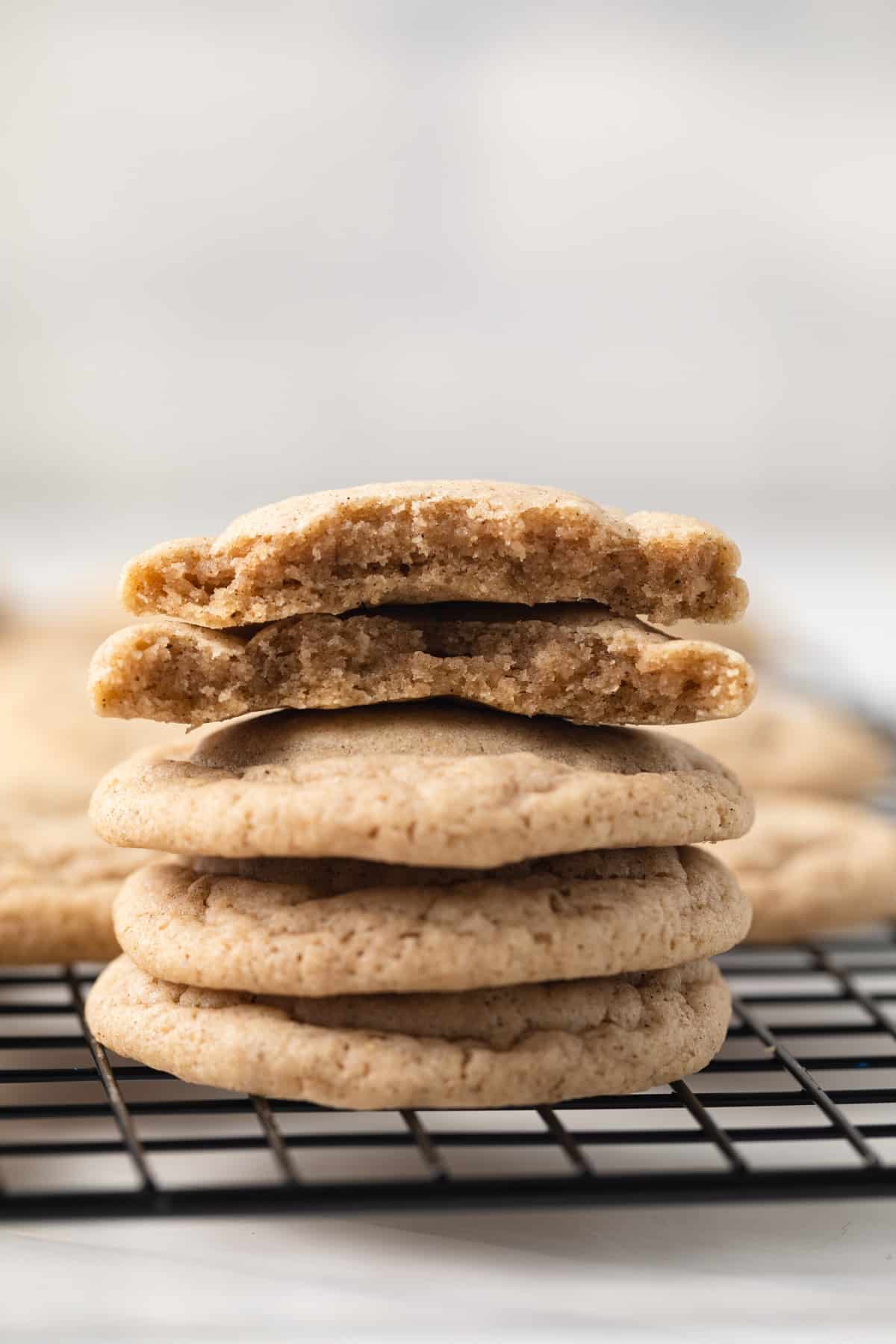 Chai cookies stacked on wire rack.