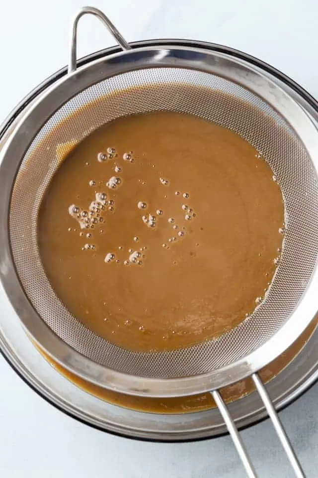 coffee custard in a fine mesh sieve