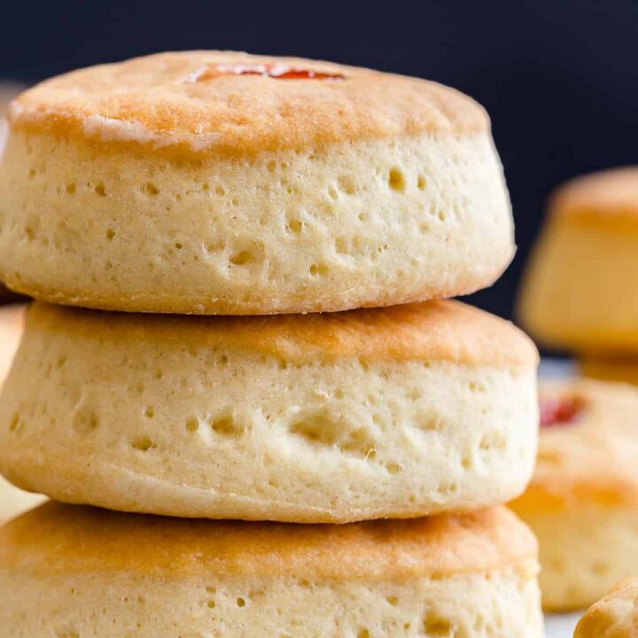 side view of three buttery jam biscuits stacked on one another