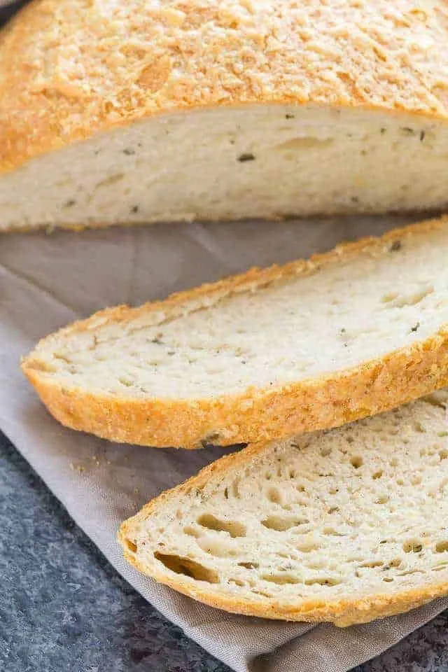 Two slices of Rosemary Cheese Bread on a gray napkin.