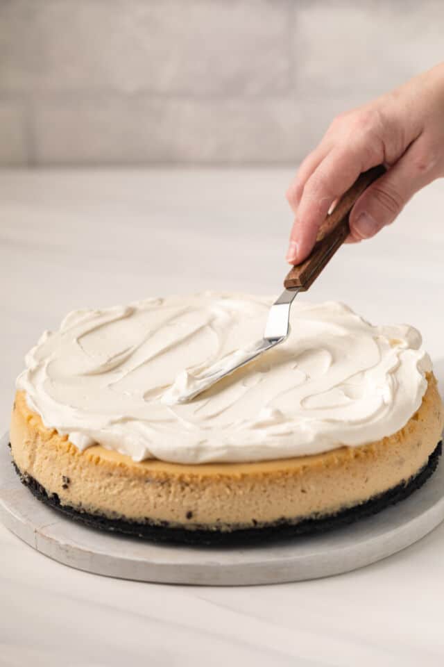 Whipped cream spread over cappuccino cheesecake.
