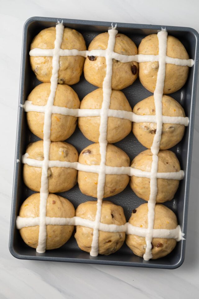 Piping roux over hot cross buns for the cross.