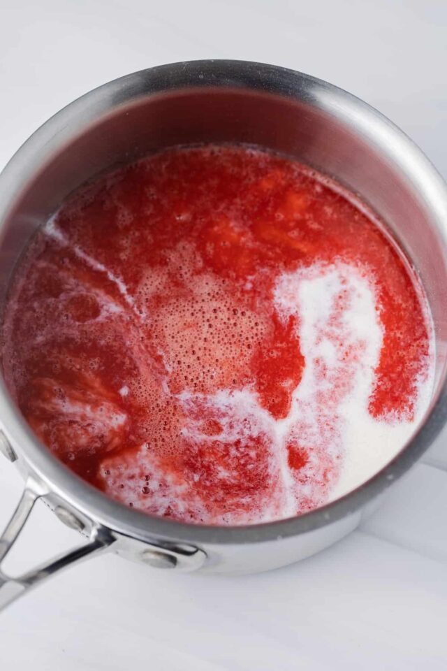 heavy cream poured into strawberry base for panna cotta