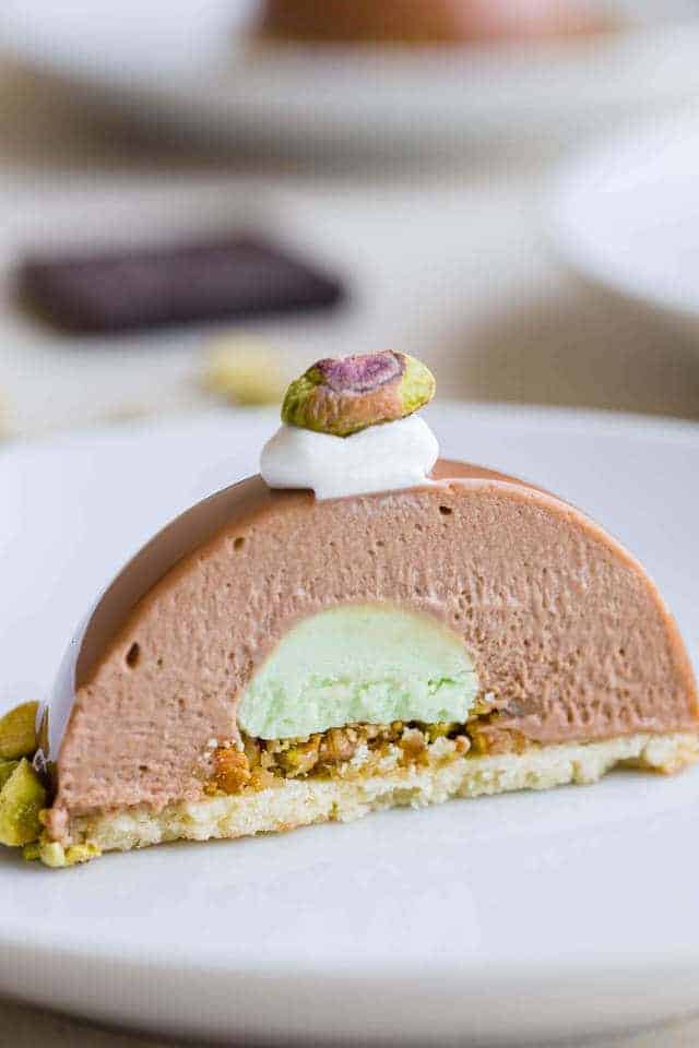 Chocolate Pistachio Dome cut in half so the inside is visible.