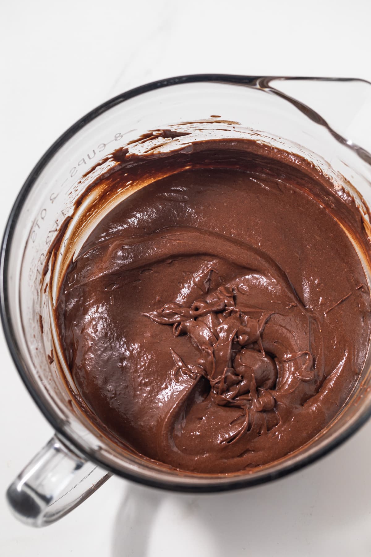 Chocolate cupcake batter in a glass bowl.