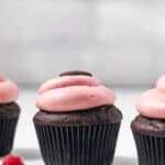 Side view of chocolate raspberry cupcakes.