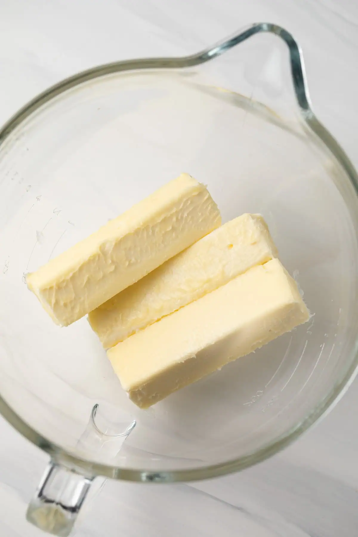 Softened butter in a glass bowl.