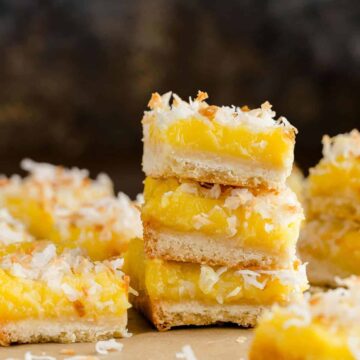Coconut lemon bars stacked on a table.