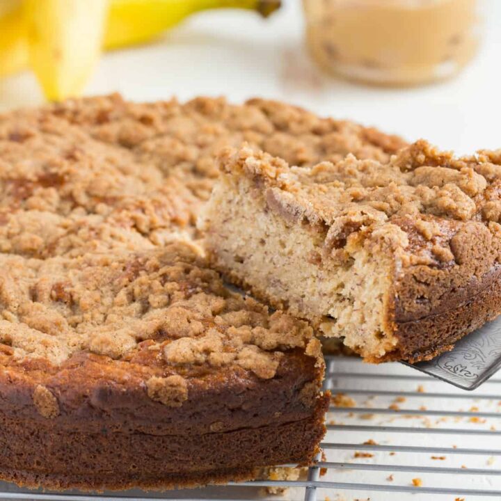 This recpeanut butter banana coffee cake with a slice being taken outipe for Peanut Butter and Banana Coffee Cake is going to have you drooling. I can think of no better way to wake up in the morning than to a large slice of breakfast cake.
