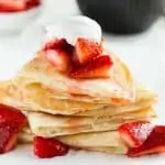 Front view of a stack of Strawberry Cheesecake Quesadillas on a marble platter.