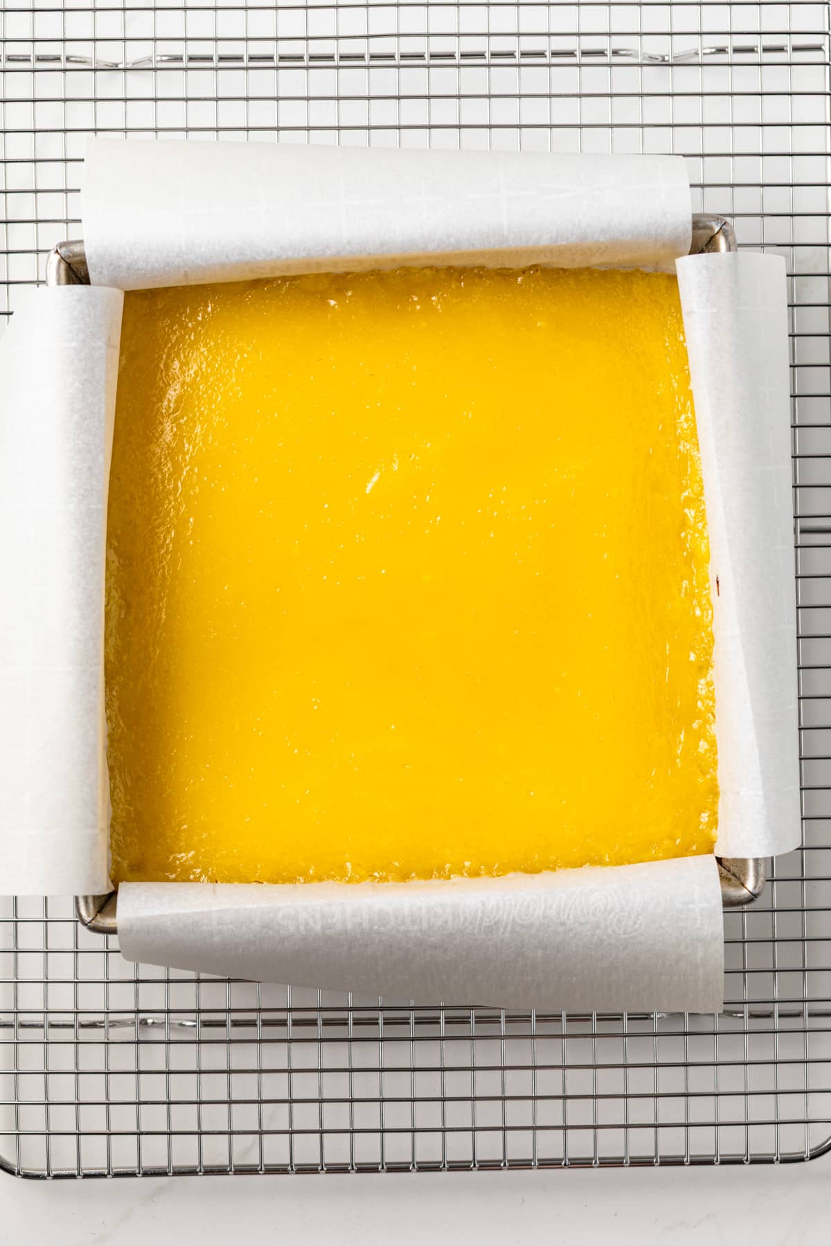 Lemon bars in a square pan.